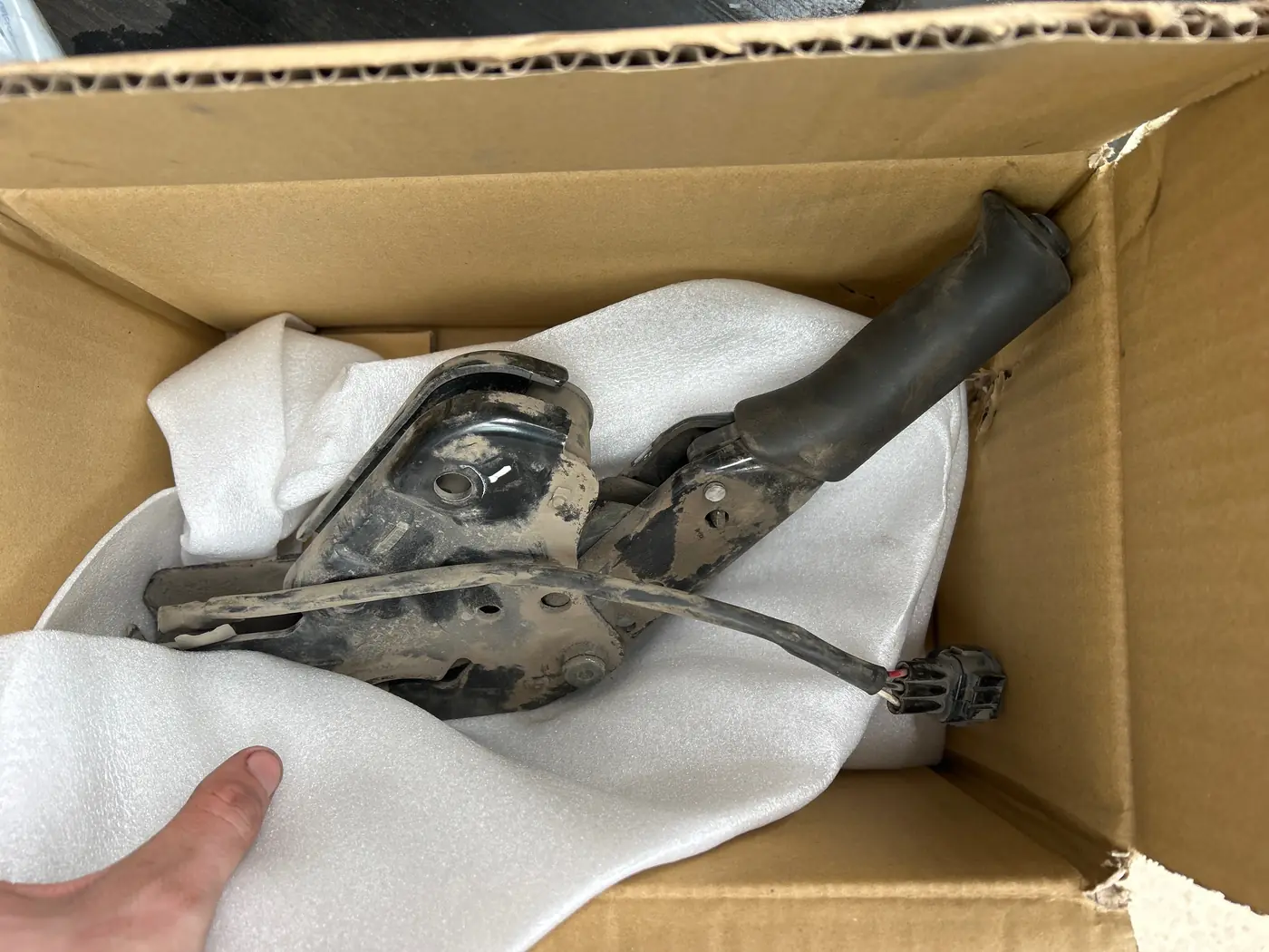 Parking brake lever assembly with mounting bracket and wiring connector in a foam-lined box