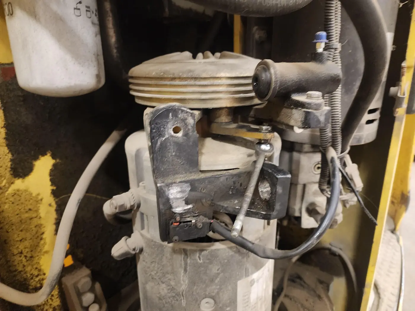 Close view of the drive-motor brake assembly with a rod extending downward beside the lever