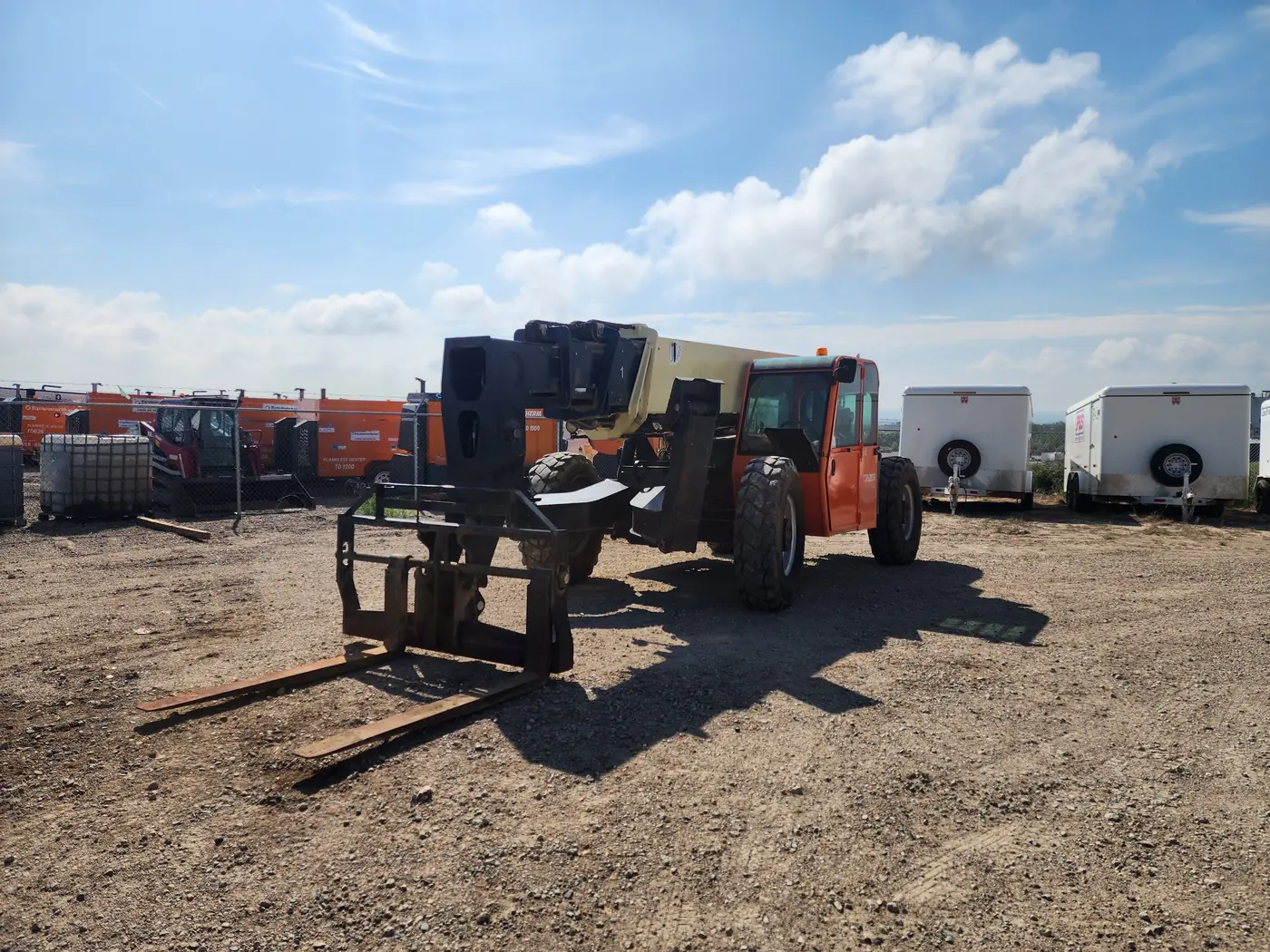 The JLG G10-55A TURB telehandler standing in a gravel yard with the boom lowered and the forks resting on the ground