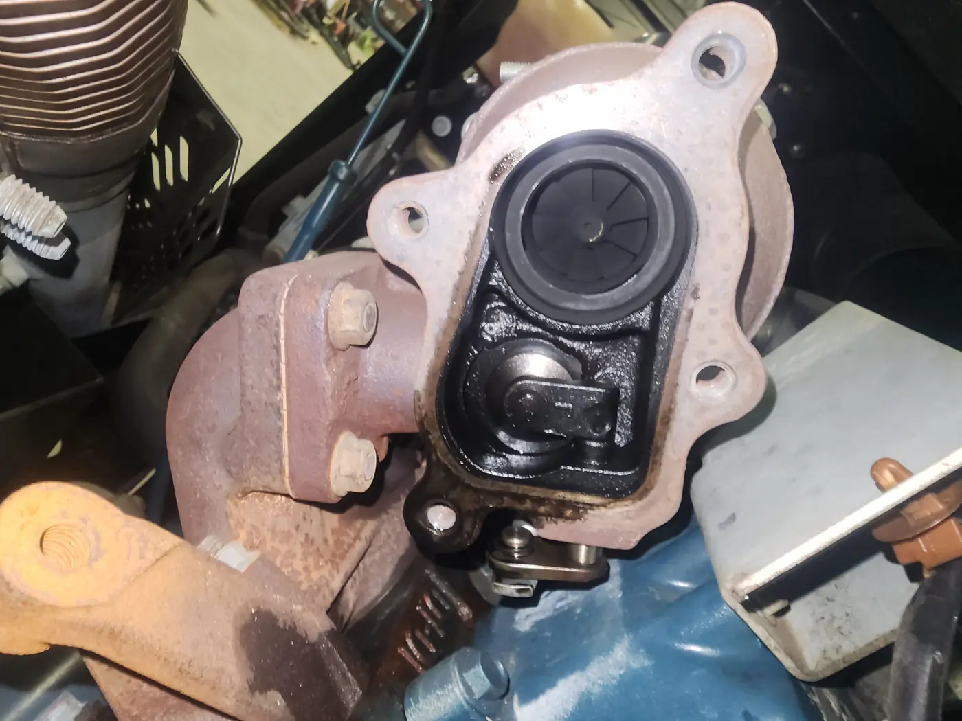 A turbocharger removed from the compressor engine and set down on the bench
