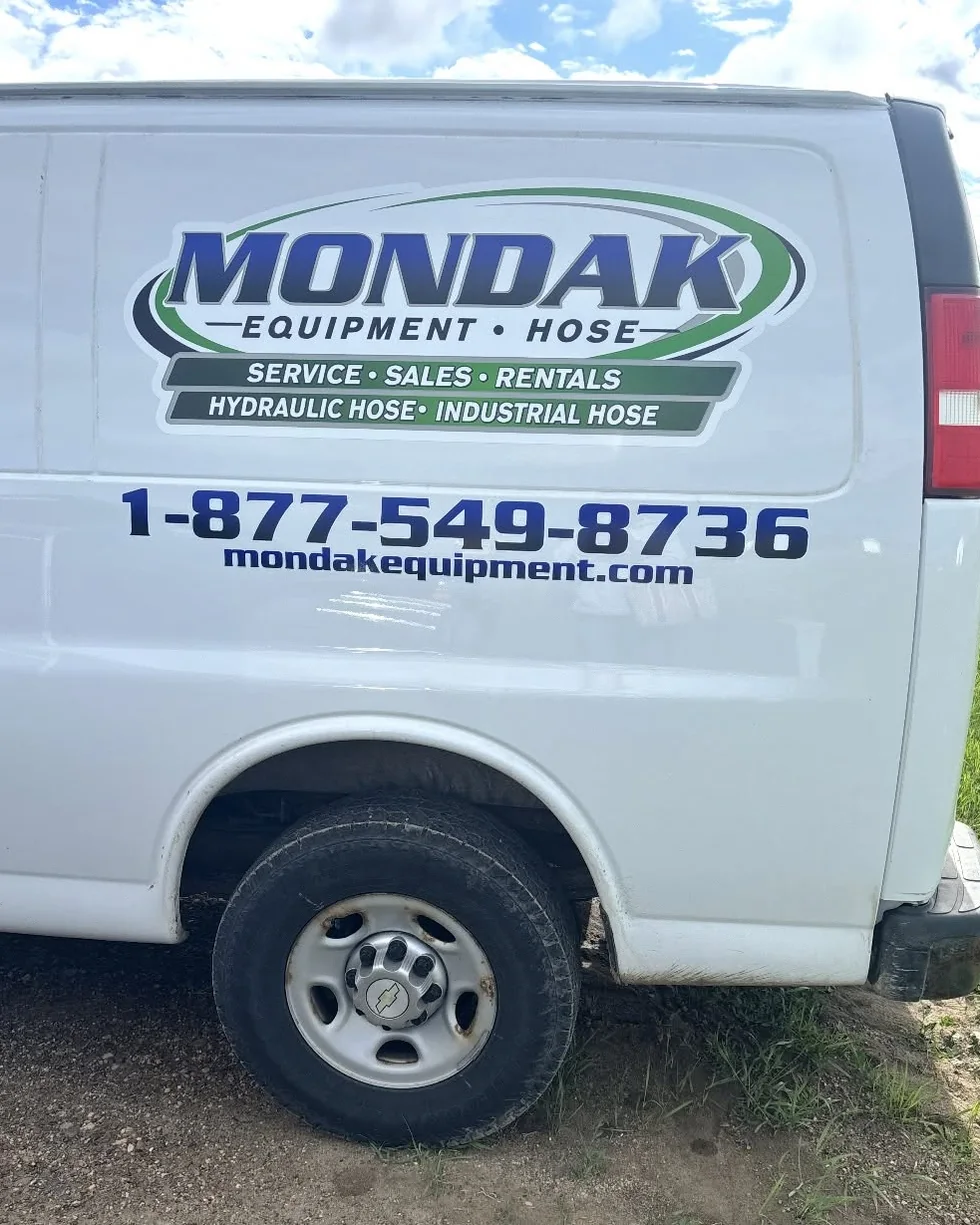 Mondak service van with the company phone number on the side